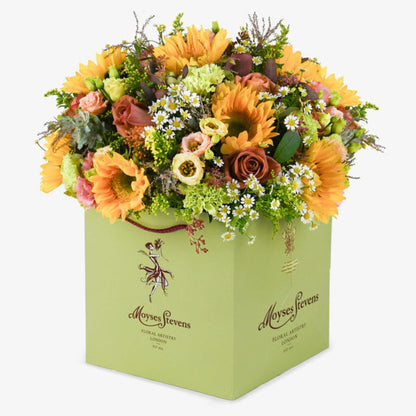 Café au Soleil luxury flower bouquet by Moyses Stevens UAE featuring golden sunflowers, barista roses, and peach lisianthus.