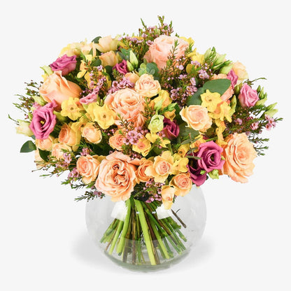 Peach Heirloom luxury flower bouquet by Moyses Stevens UAE featuring ruffled peach petals with the deep, saturated hues of fragrant lisianthus. Accented with the dainty charm of spring bulbs and ethereal pink waxflower.
