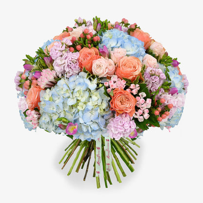 Blue dawn luxury flower bouquet by Moyses Stevens UAE featuring pink bouvardia, hypericum, spray roses, freesias and carnations to make the design truly irresistible