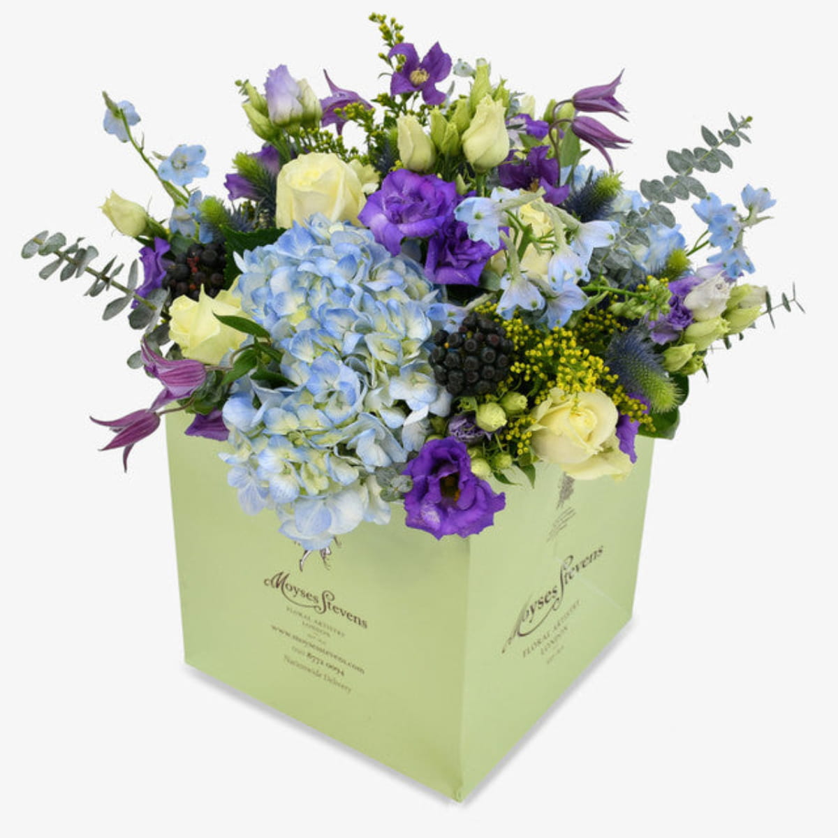 Blue sky luxury flower bouquet by Moyses Stevens UAE featuring Blue Hydrangeas, White Roses, Purple Lisianthus, Purple Clematis, Blue Delphinium, Yellow Solidago, Eucalyptus