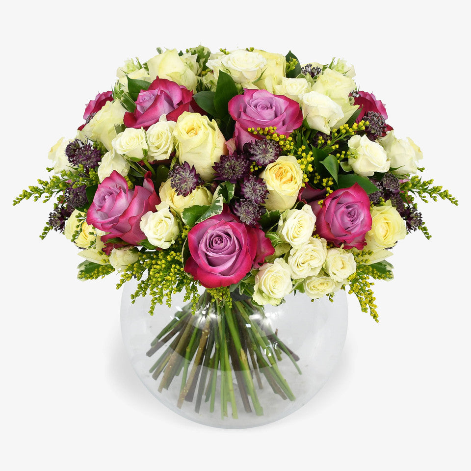 Lemon Meringue luxury flower bouquet by Moyses Stevens UAE featuring yellow and deep purple roses, white spray roses, solidago and astrantia and  seasonal greenery.