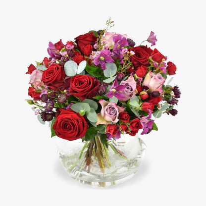 Rennaisance Rose luxury flower bouquet by Moyses Stevens UAE featuring a variety of red and pink roses, spray roses, clematis, wax flower, astrantia, and eucalyptus.