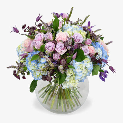 Wild Meadow luxury flower bouquet by Moyses Stevens UAE featuring Delicate lisianthus, roses, and ranunculus which are nestled among cymbidium orchids, while hydrangeas and astrantia provide a stunning backdrop.